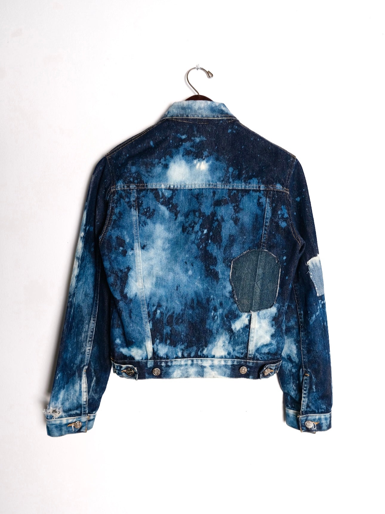(hanger back): Bleached Patchwork Denim Jacket – back on hanger, dark indigo bleach tie-dye trucker jacket with circular denim elbow patch, upcycled – Lillies Studios