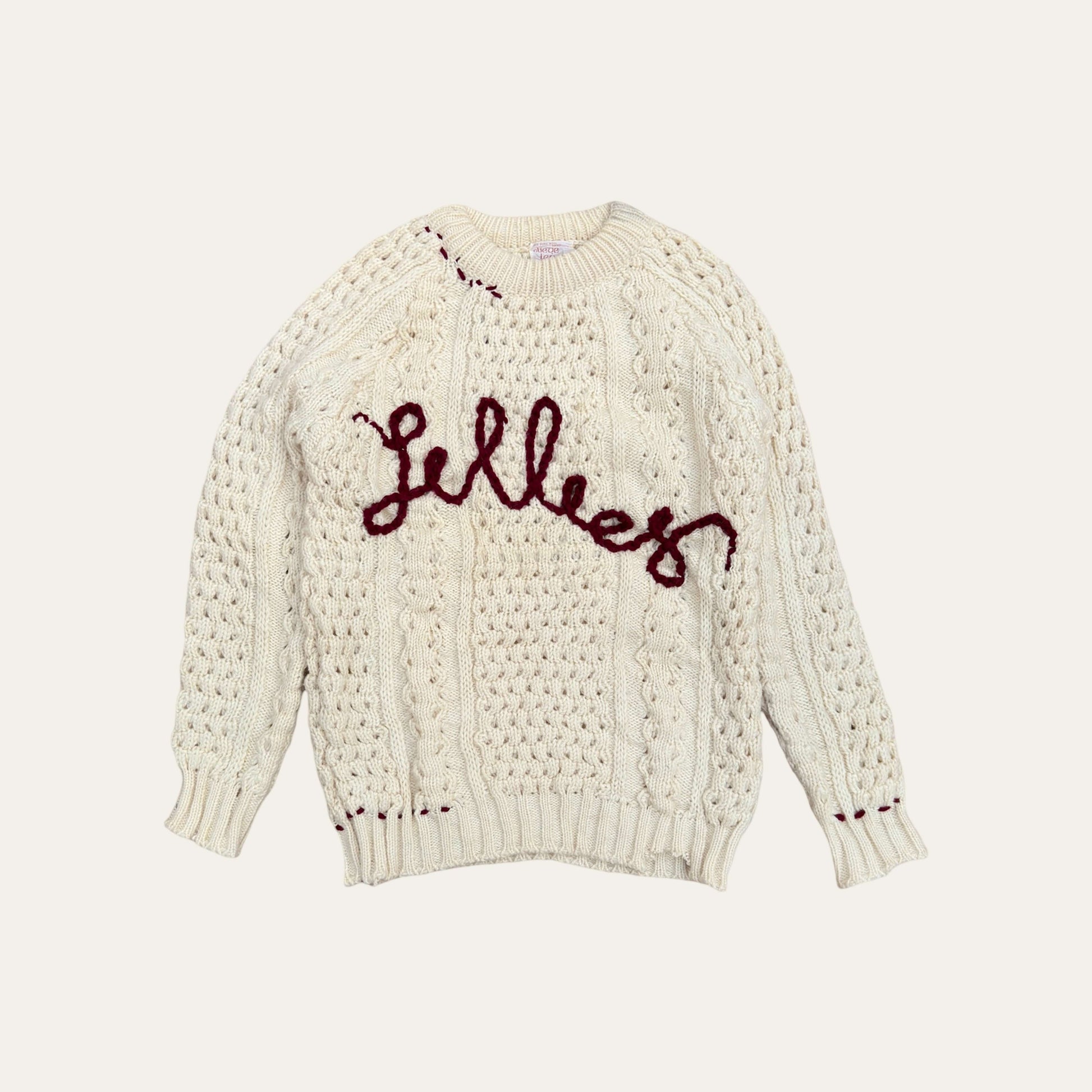 Hand-embroidered fisherman sweater with vintage inspired typography, crafted from genuine second-hand Irish Aran Sweaters.