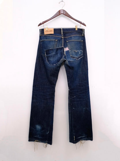 (hanger back): Japanese Selvedge Patchwork Denim – back on hanger with Lillies leather label, dark indigo selvedge jeans with patchwork back pockets, upcycled – Lillies Studios