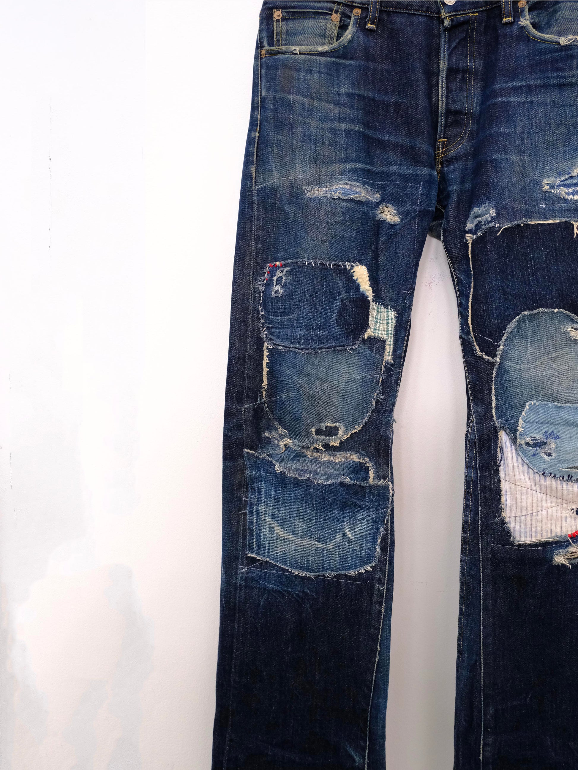 (front lower detail): Japanese Selvedge Patchwork Denim – lower leg detail, dark indigo selvedge denim with layered mixed fabric patchwork – Lillies Studios