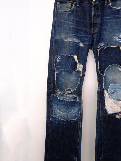 (front lower detail): Japanese Selvedge Patchwork Denim – lower leg detail, dark indigo selvedge denim with layered mixed fabric patchwork – Lillies Studios