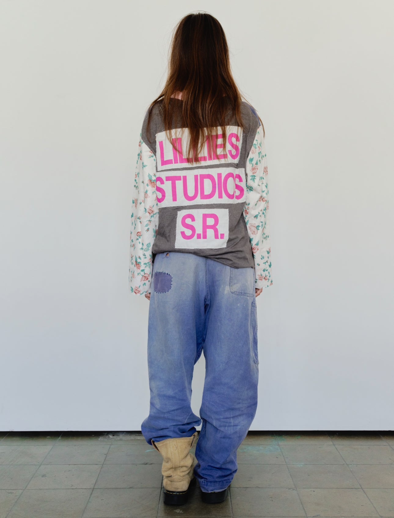 Long Sleeve Up-cycled Vintage Tee – back view worn, grey body with pink Lillies Studios S.R. graphic and floral patchwork sleeves, styled with wide-leg jeans – Lillies Studios
