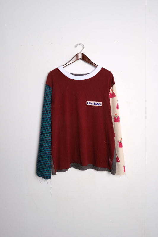 Long Sleeve Up-cycled Vintage Tee – front on hanger, burgundy body with teal check left sleeve and cream novelty print right sleeve, Lillies Studios chest patch, upcycled – Lillies Studios