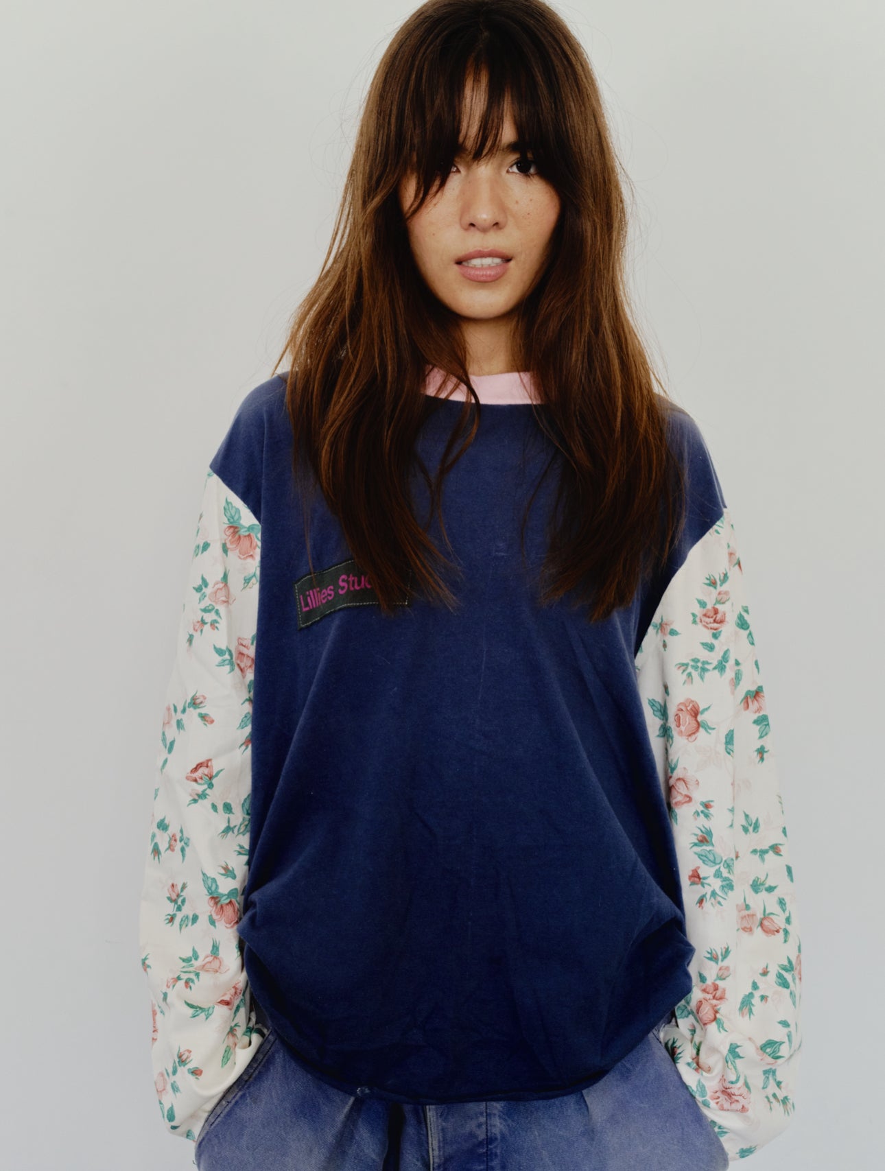 Long Sleeve Up-cycled Vintage Tee – front close-up worn, navy body with Lillies Studios chest patch and cream floral sleeves – Lillies Studios