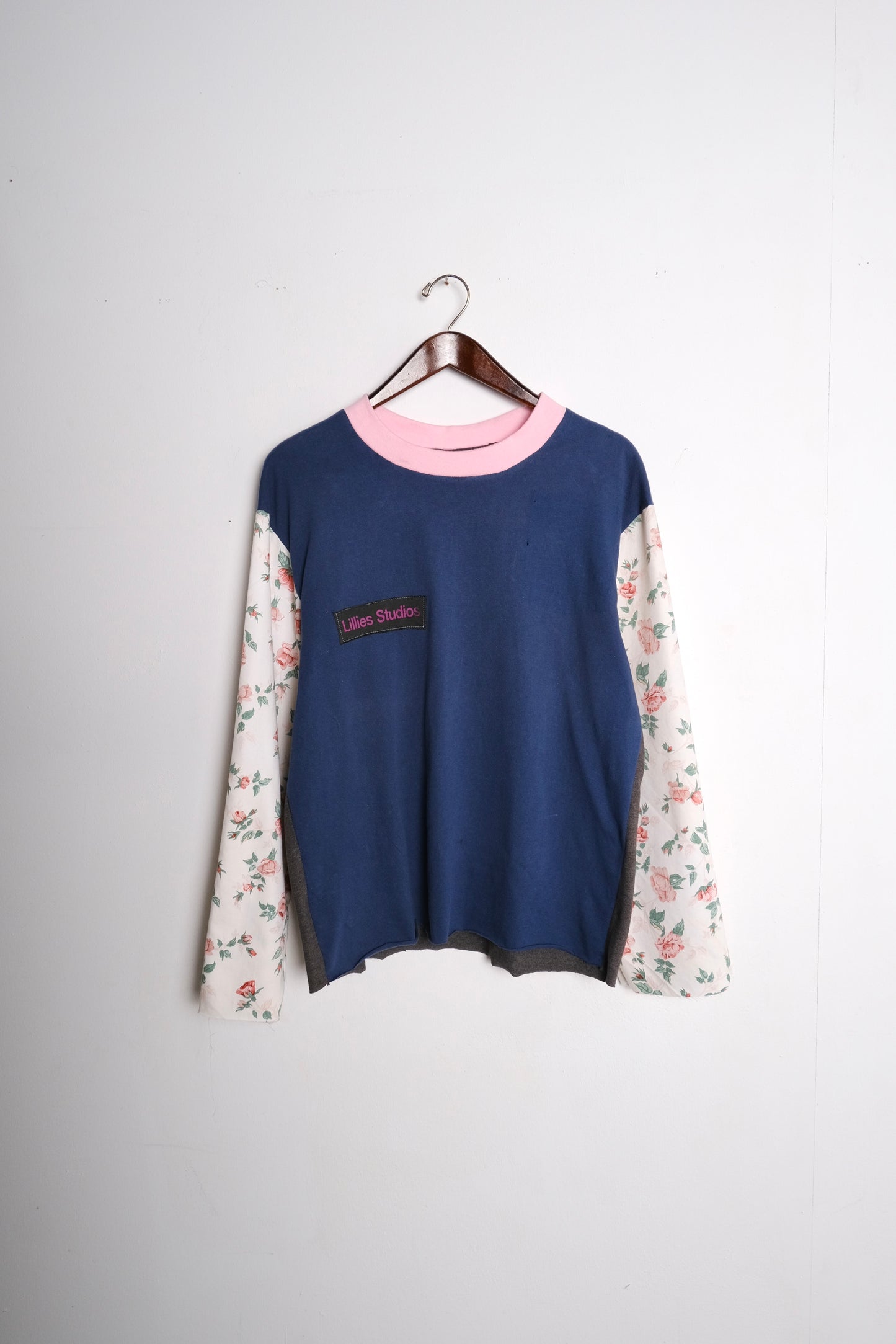 Long Sleeve Up-cycled Vintage Tee – front on hanger, navy body with pink ringer collar and cream floral patchwork sleeves, Lillies Studios chest patch, upcycled – Lillies Studios
