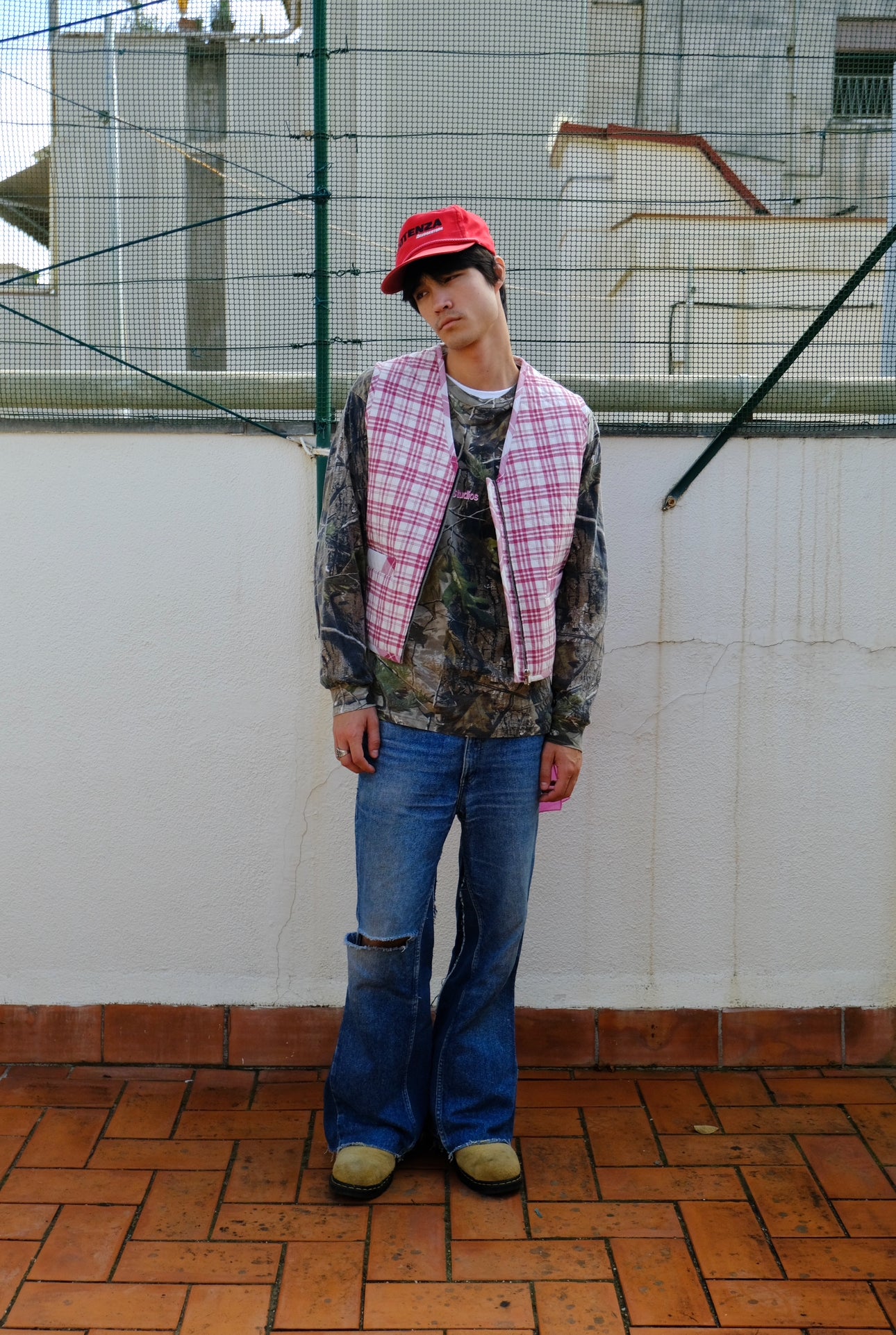 (worn front): Up-cycled Grandmother's Vest – front view worn, pink plaid quilted zip vest styled with camo jacket and flare jeans – Lillies Studios