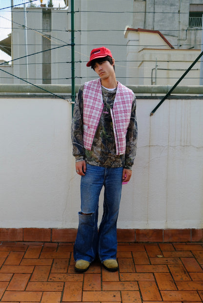(worn front): Up-cycled Grandmother's Vest – front view worn, pink plaid quilted zip vest styled with camo jacket and flare jeans – Lillies Studios