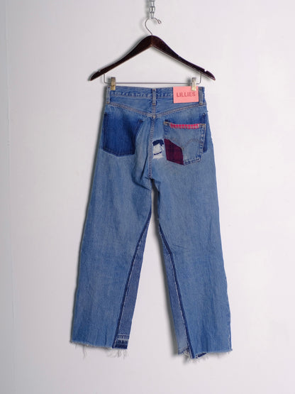 Vintage Repair Patchwork Jeans – back on hanger with Lillies Studios pink label, light wash jeans with dark denim and burgundy patchwork back pocket repairs, upcycled – Lillies Studios