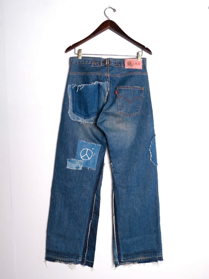 (hanger back): Wide Leg Japanese Patchwork Denim – back on hanger with Lillies Studios pink label, mid-wash wide-leg jeans with peace sign patch, upcycled – Lillies Studios
