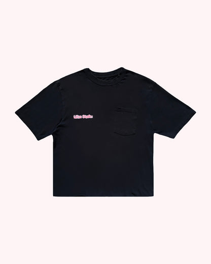 Black t-shirt with a small pink logo on a white background